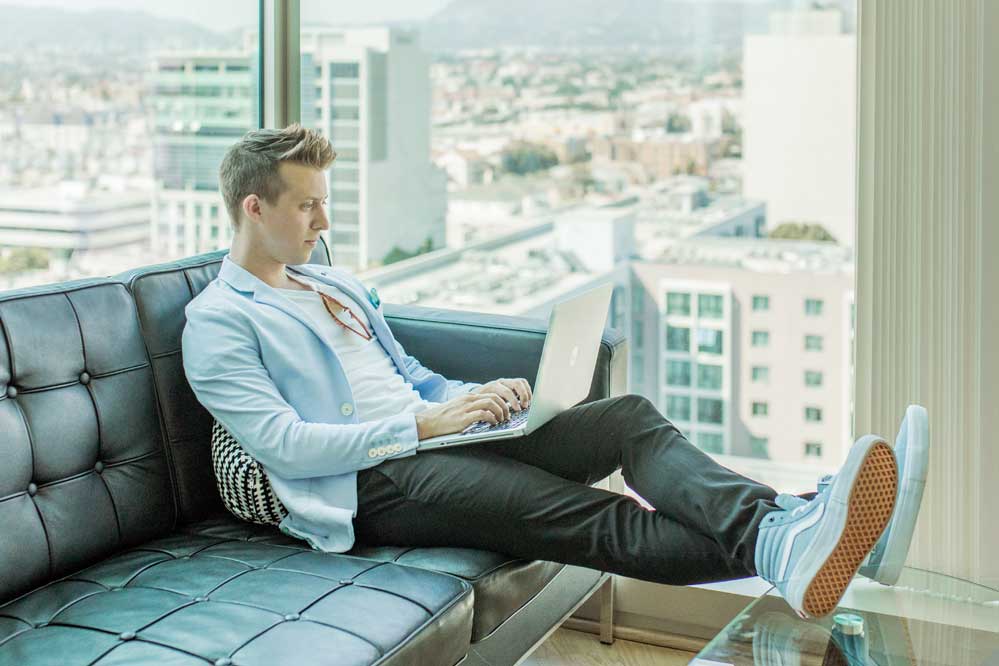 Man sitting with his laptop checking business efficiency